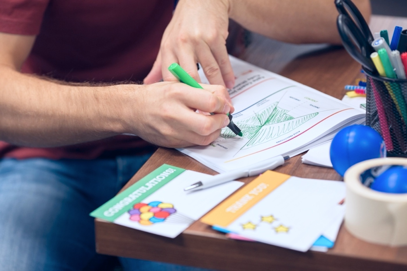 Participant filling a coaching worksheet with markers